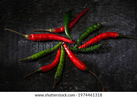 red and green hot peppers on dark gray background dark mood style 