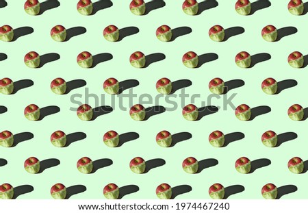 Pattern of bitten apples on green background