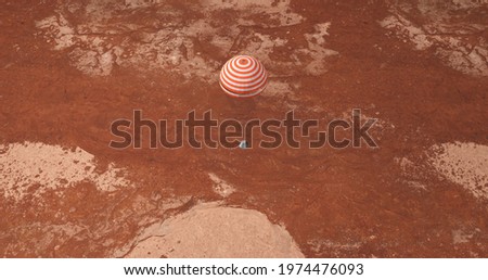 Spaceship landing on Mars with parachute Royalty-Free Stock Photo #1974476093