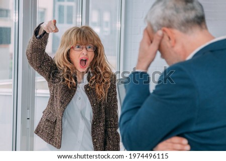 business woman firing worker in office Royalty-Free Stock Photo #1974496115