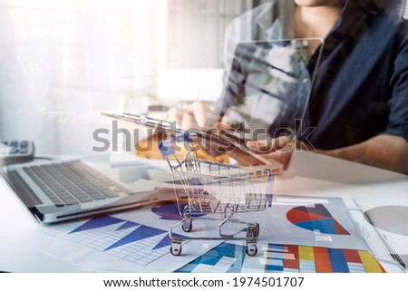 Business women reading document on office with tablet and graph financial diagram.Teamwork workplace strategy Concept.