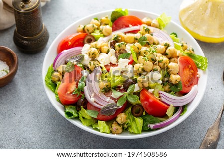 Healthy spring Greek salad with fresh vegetables and seasoned chickpeas