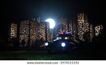 Cartoon style city buildings. Realistic city building miniatures with lights. background. Miniature police standing with City lights on the background. Selective focus