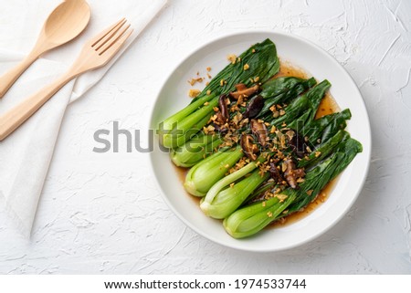 Baby Bok choy or chinese cabbage in oyster sauce with Shitake Mushrooms and fried garlic.Top view Royalty-Free Stock Photo #1974533744
