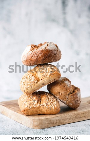 Various buns made from whole grain or plain flour on a wooden board. Traditional bakery products. Bakery products. Bakery. Royalty-Free Stock Photo #1974549416