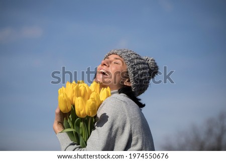 image of cute woman with bouquet. Tulips. Flowers. Background. 
