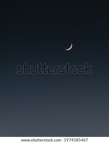 A minimalist picture of half moon in the sky isolated on the dark background