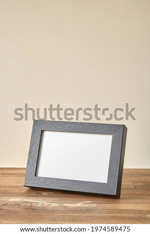 A studio photo of a black photo frame