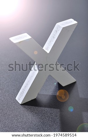 A studio photo of the symbol x