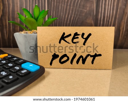 Business concept.Text KEY POINT with calculator on light table.