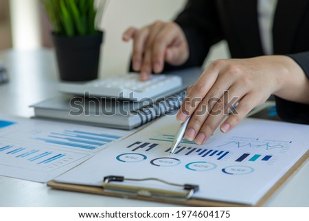 Close up of Accounting businesswoman working on note laptop computer and analyzing real estate investment data, Financial and tax systems concept.