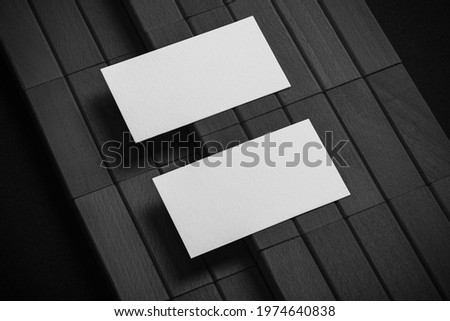 Minimal business card mockup on black wooden background