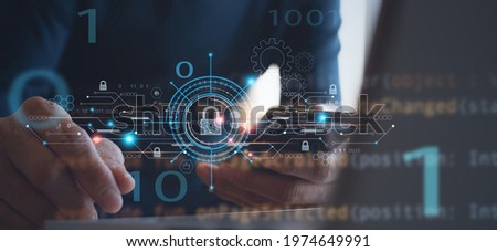 Personal data protection, antivirus software development, internet network, cyber security concept. Man using mobile phone with virtual padlock and technology icons and computer code on virtual screen Royalty-Free Stock Photo #1974649991