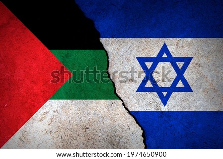 Flags of Israel and Palestine painted on cracked wall background. Concept of the Conflict between Israel and the Palestinian Authorities. Royalty-Free Stock Photo #1974650900