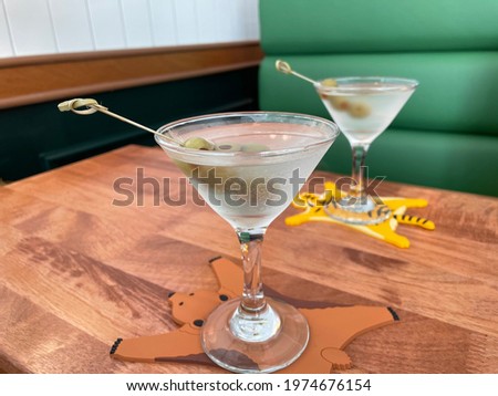 Gin martini with olives on animal coasters