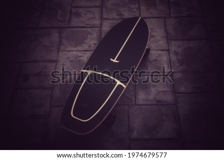 Land surf skate board on stone dark outdoor stone tile floor