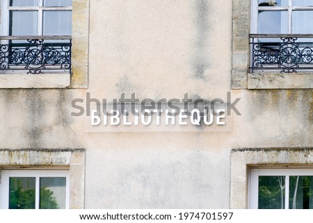 bibliotheque sign french text on facade of Old French Village Building Municipal Library in city center