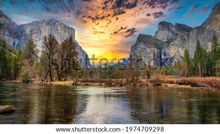 Scenic panoramic view of famous Yosemite Valley with El Capitan rock climbing summit and idyllic Merced river on a beautiful day with blue sky in summer, Yosemite National Park, California, USA Royalty-Free Stock Photo #1974709298