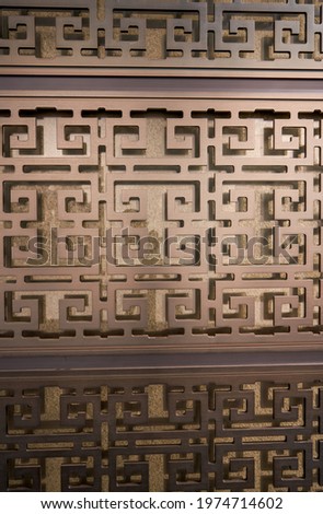 Close-up of a dark golden metal gate pattern