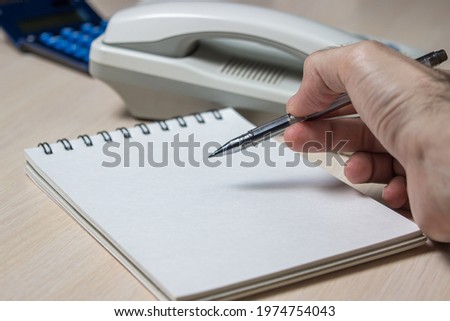 Office work. Business development concept. Increased sales. Sales management. Hand writes in notebook