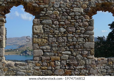 Ruined medieval castle window with seascape view 