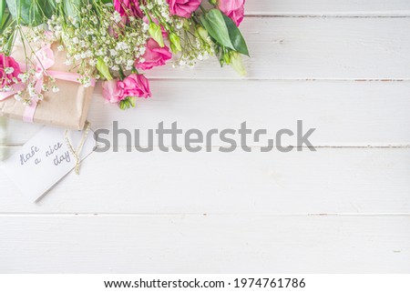 Bouquet of spring, summer flowers, coffee cup and notes good morning, have a nice day on white wooden table. Summer morning beautiful breakfast, greeting card, top view, flat lay. Mother day concept