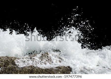 Water wave splashes, isolated on black background Royalty-Free Stock Photo #197477396