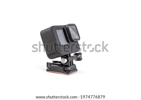 New 4K action camera on a suction mount in black color. Isolated on  white background