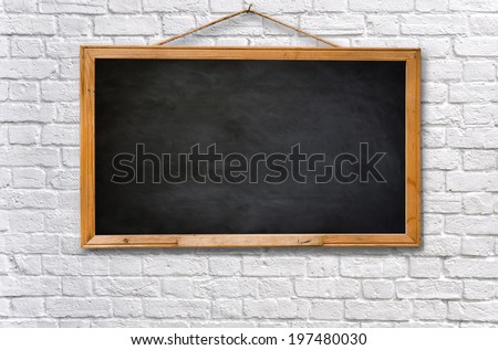 Empty black board on white brick wall texture background