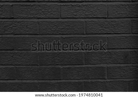 Close-up of the dark brick background. Black, carbon painted wall brick. Textured surface, backdrop.