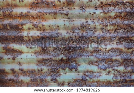 weathered rusty metal door or fence of a garage - weathered steampunk background with horizontal lines