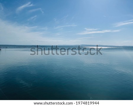 Beautiful shot of a long pier on the water under a bright sunny sky