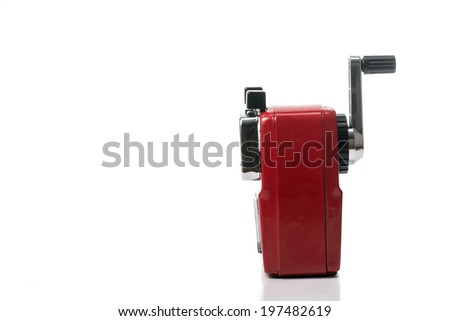 Red color metal pencil sharpener isolated with white background