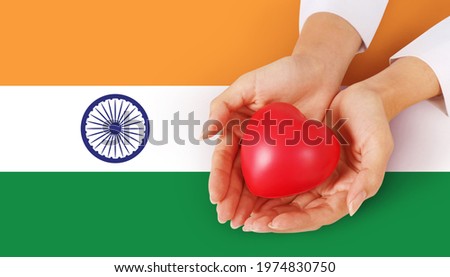 Hand holding red heart Health Care Caring sign on white india flag background. Royalty-Free Stock Photo #1974830750