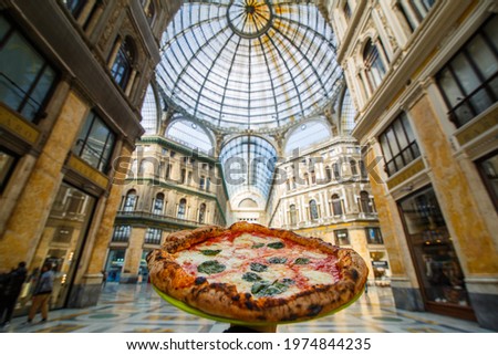 Pizza Margherita Napoletana with tomato, basil and buffalo mozzarella photographed under the Galleria Umberto in Naples Royalty-Free Stock Photo #1974844235