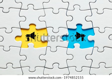 Missing puzzle pieces with megaphone icons. Communication, discussion, chatting, conversation, argument or negotiation concept. Royalty-Free Stock Photo #1974852155