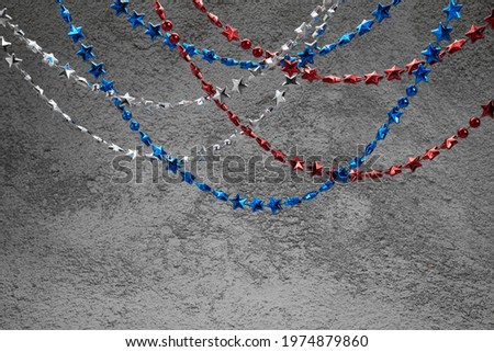 American Independence Day red blue white stars beads on on Dark Concrete Background. USA flag colors stylish fourth of july wallpaper.