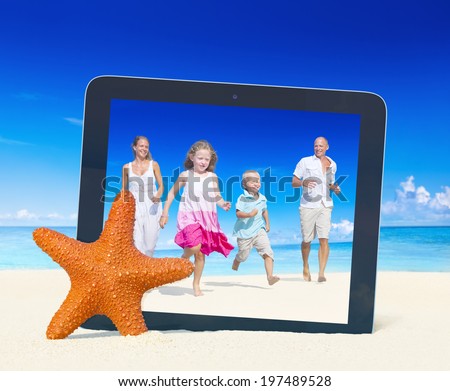 Family having fun on the beach with tablet pc frame.