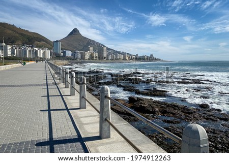 Sceniv view of Sea Point Promenade with scenic view Seapoint district and Lion’s Head Peak, Cape Town, South Africa against blue sky Royalty-Free Stock Photo #1974912263