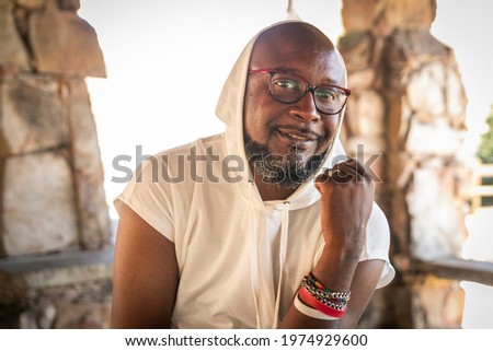 Healthy black man living with HIV sitting in a picnic area at a park