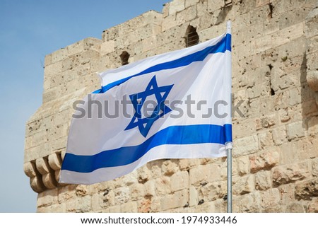 flag of Israel against the sky and the wall