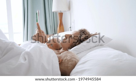 Young Sister On Parents Bed