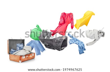 The concept of moving. Clothes fly from the suitcase isolated on a white background. Delivery concept