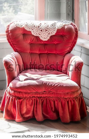 vintage tufted dusty pink velvet rocking chair with lace antimacassar and ruffle sitting in corner of room Royalty-Free Stock Photo #1974993452