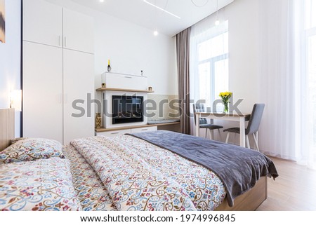 Interior photography, modern bedroom, with large stylish bed, modern design, whith small kitchen