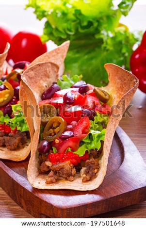 Mexican tacos in tortilla shells with fresh vegetables