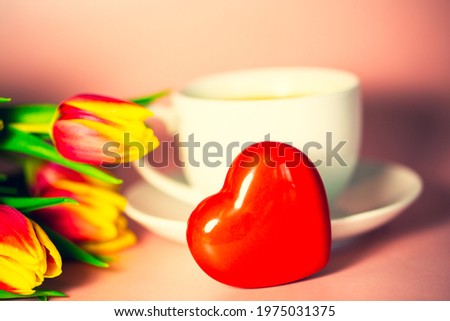 cup of coffee with tulips and heart