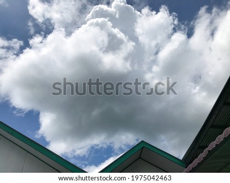 The roof of my house against the background of the blue sky with clouds.  clear sky in the sky of Indonesia