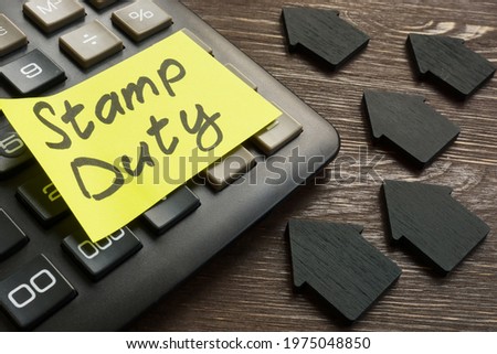 Memo stamp duty land tax on the black calculator. Royalty-Free Stock Photo #1975048850