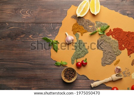 World map made of different spices on wooden background Royalty-Free Stock Photo #1975050470